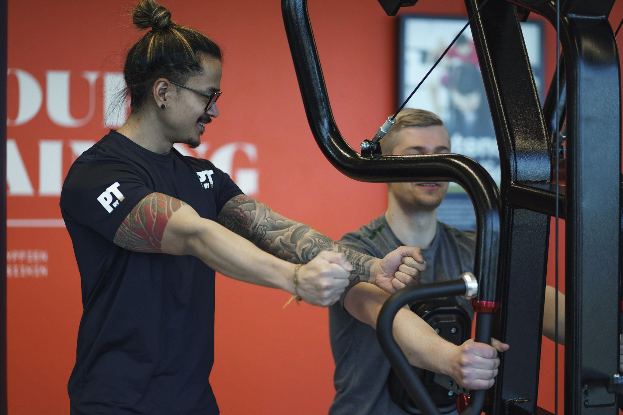 Personal trainer assisting row